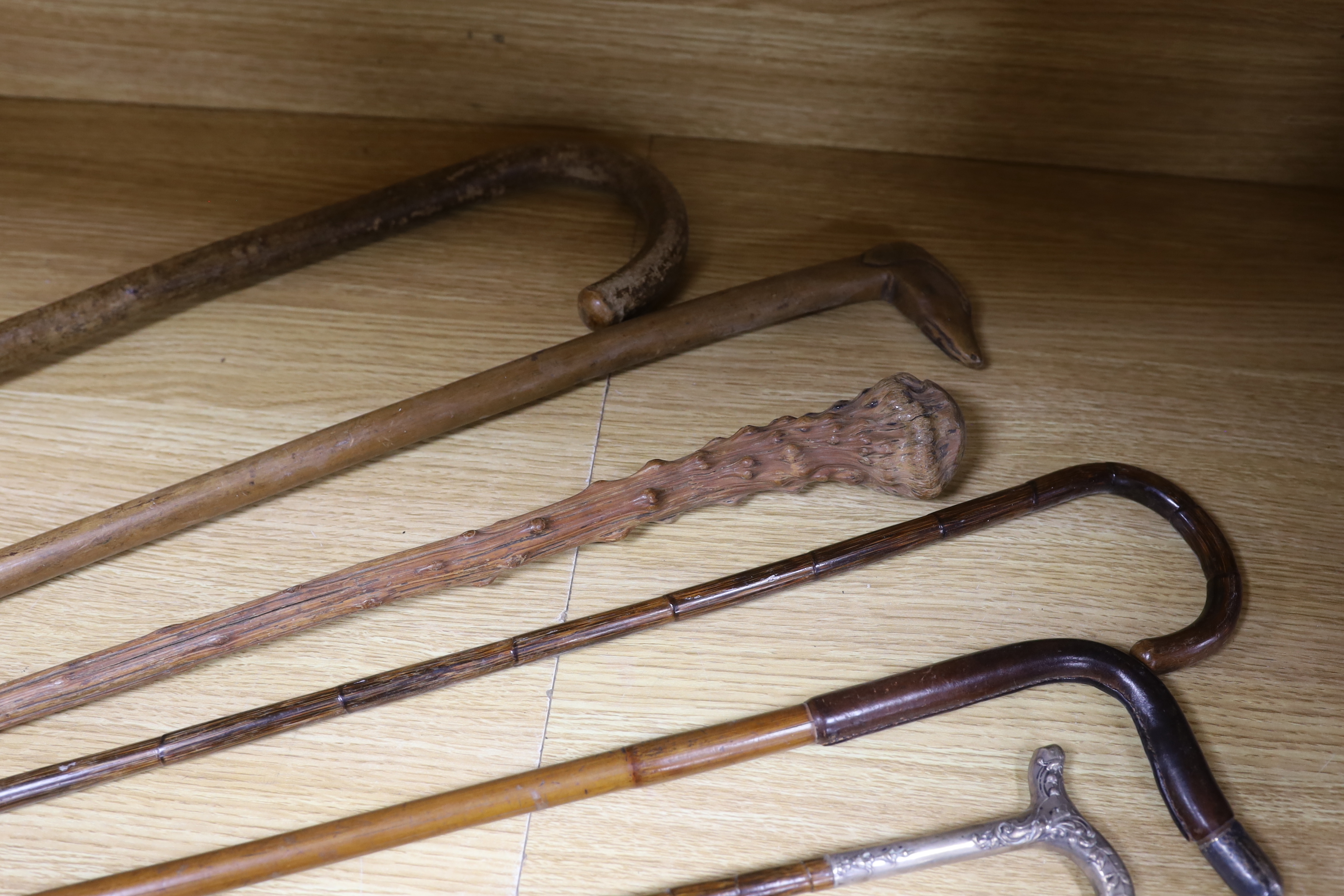 Four various decorative Victorian silver mounted walking sticks/canes, three horn handled canes and four others